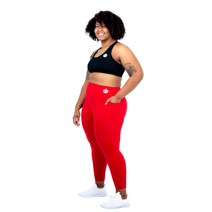 Model Skyler in ICONI Black Sports Bra and Red Full Length Legging