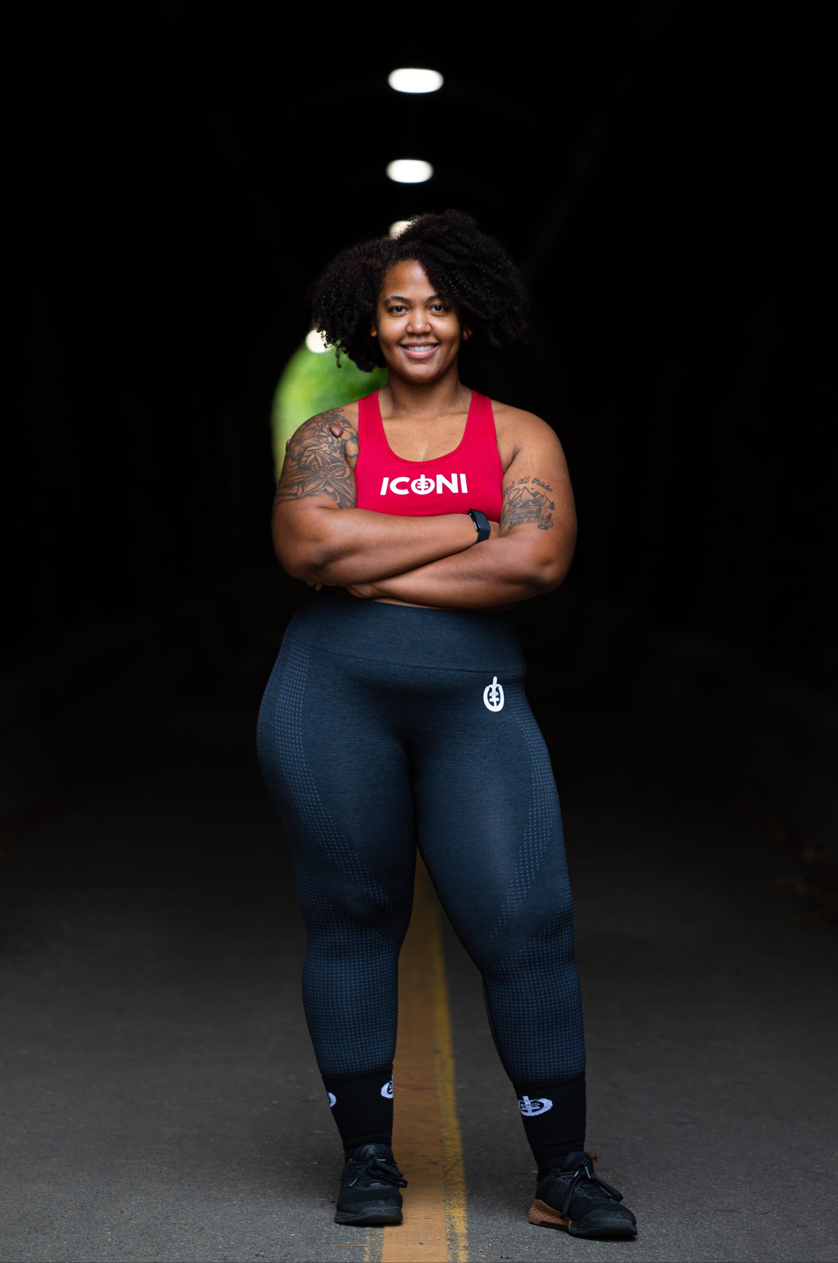 Woman standing firmly in ICONI sports bra and legging