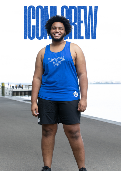 Photo of man in blue ICONI tank and black ICONI shorts with the words ICONI Crew behind him